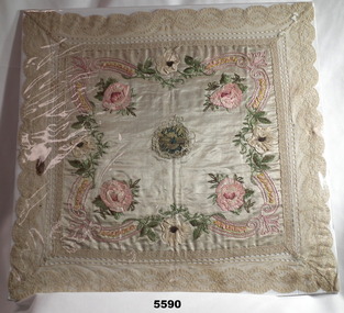EMBROIDERED FLORAL CLOTH WITH LACE EDGING.