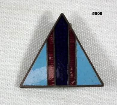 Triangle shaped metal and enamel unit badge representing the Australian Flying Corps.