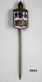 Metal and enamel badge with religious crest and stick pin.