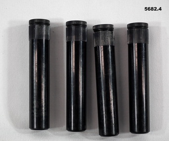 Four black plastic oil bottles.