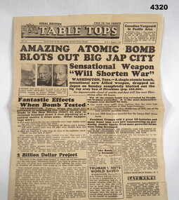 Table tops newspaper reporting on the Atomic bomb.
