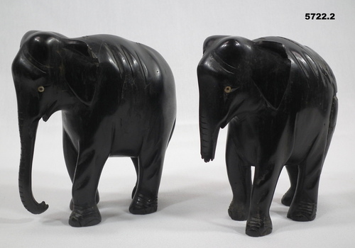 Two carved wooden elephants.
