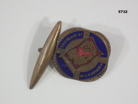 Single metal and enamel cuff link presented as a souvenir of MV Kanimbla.