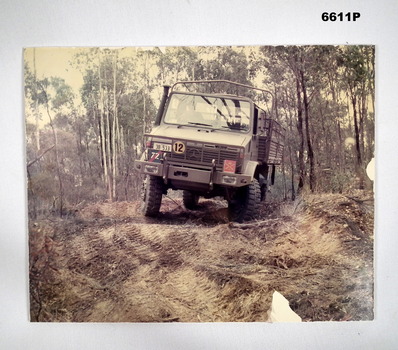 Army truck driving on rough tracks.