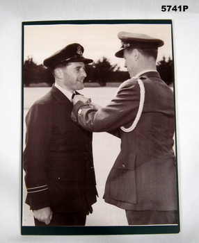 Black and white photograph of an Army officer presenting a RAAF officer with a medal.