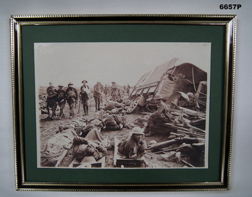 Framed photograph depicting WW1 soldiers on battlefield.