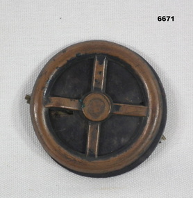 Metal Drivers Badge depicting a steering wheel.