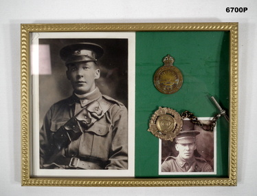 Photo and medals in a photo frame.