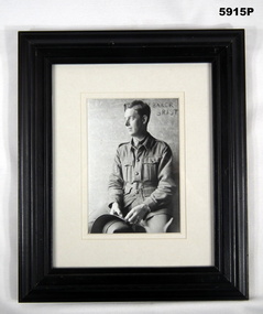 Framed black and white portrait photograph of a soldier WW1.