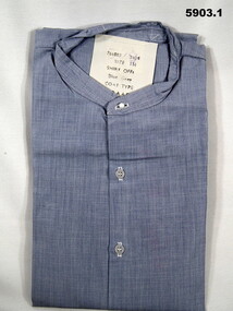 Collarless light blue RAAF shirt with long sleeves.