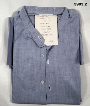 Collarless light blue RAAF shirt with long sleeves.