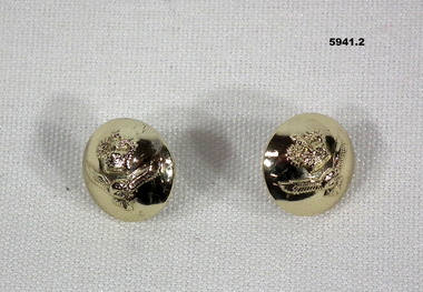 Two small gold coloured buttons with RAAF insignia.