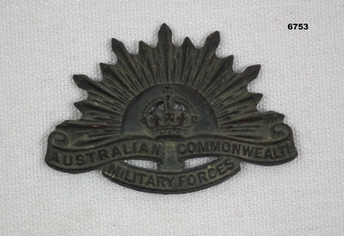 Black metal Rising Sun Badge.