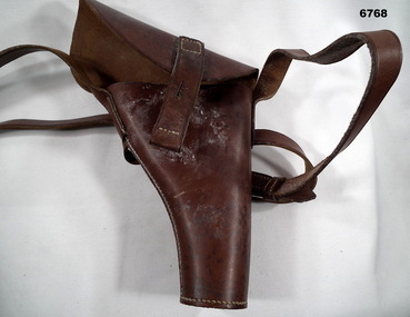 Pistol holster with shoulder strap.