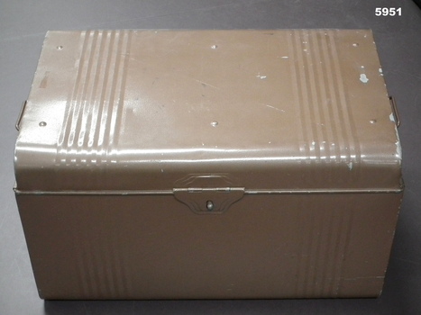 Large brown painted metal trunk with handles and catch.