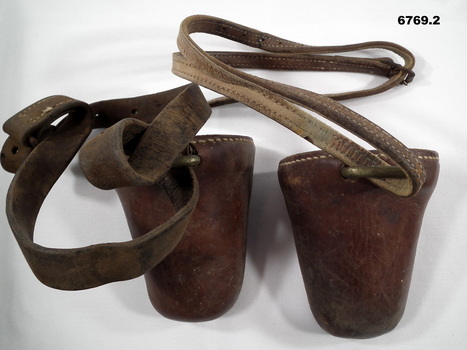 One pair of brown leather foot stirrups.
