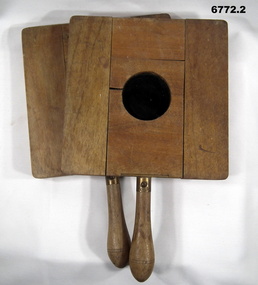 Two wooden aircraft landing paddles.