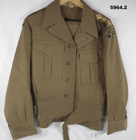 Khaki battle dress jacket and trousers with RAASC badges.