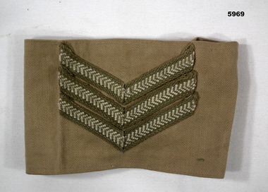 Temporary Sergeant's khaki armband with missing fastener.