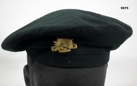 Dark green beret with Rising Sun badge.