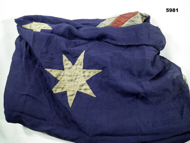 Older cotton Australian Flag in poor condition.