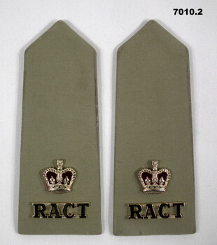 Pair of khaki coloured shoulder boards, each with a Queen's Crown and Corps badge.