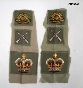 Two sets of three cloth Army badges.