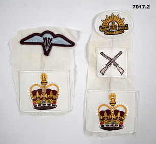 Two sets of cloth Army badges.