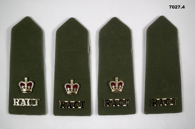 Four jungle green coloured shoulder boards, three with rank insignia.