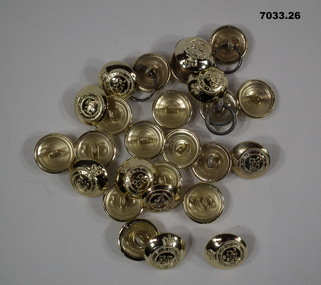 Collection of 26 large round gold coloured jacket buttons with insignia.