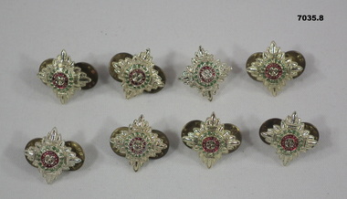 Eight silver colour pips representing Army rank.