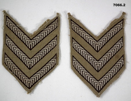 Two sets of Sergeant stripes for a shirt.