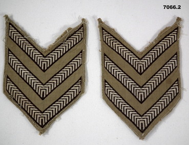 Two sets of Sergeant stripes for a shirt.