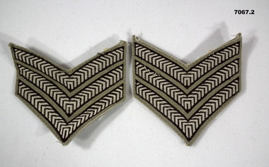 Two sets of Sergeant's stripes for a shirt.