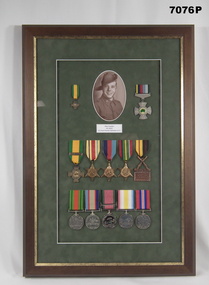 Framed set of medals with photo of a POW.