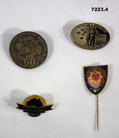 Four badges to commemorate Anniversary of Bombing of Darwin.