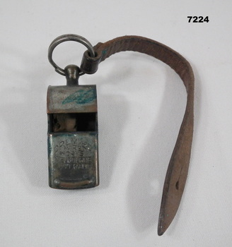 Military whistle on leather strap.