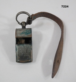 Military whistle on leather strap.