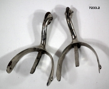 One pair of silver metal stirrups.