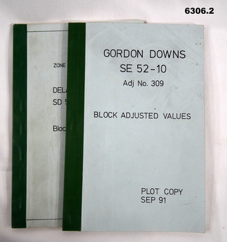 Blue covered booklets green tape binding containing data values for Block adjustment.