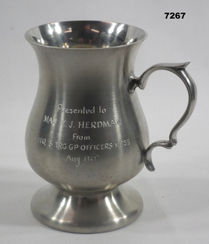 Silver coloured metal tankard with handle.