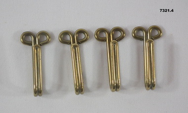 Brass keepers for a ceremonial belt.
