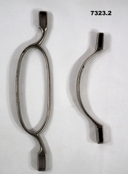 Two metal kit bag handles, one oval shaped and one U shaped.