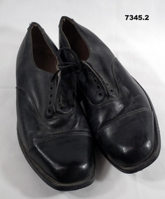 Pair of black leather shoes.