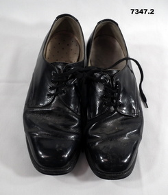 Pair of black patent leather shoes.