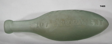 Torpedo shaped green glass bottle.