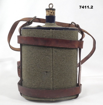 Enamel water bottle and leather carrier.