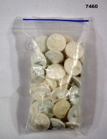 White plastic buttons with navy motif.