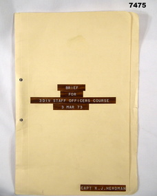 Foolscap manila folder containing typed notes on white pages.