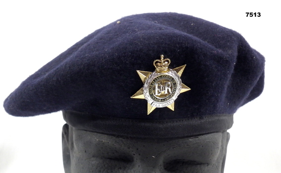Navy Blue felt beret with unit insignia.
